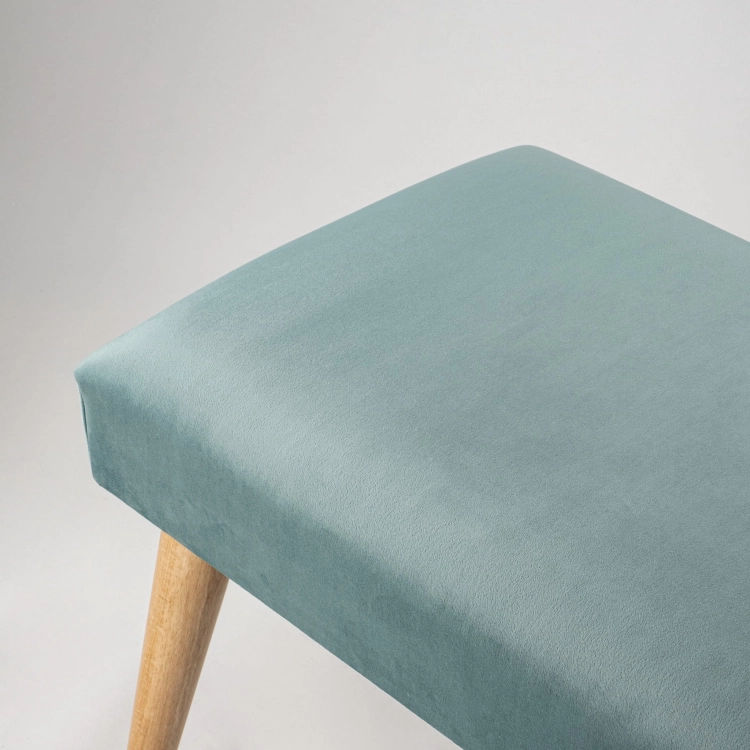 Elegante mintfarbene Bank mit Polsterung und Holzbeinen